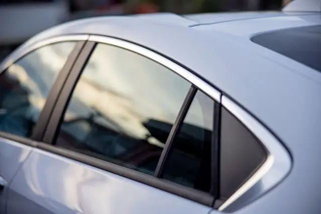 Close-up of a silver car's clean side windows