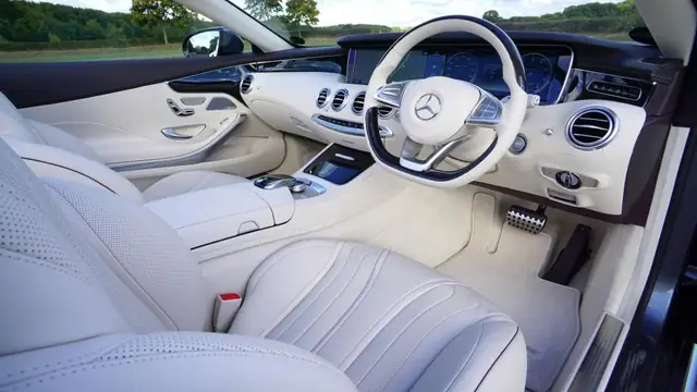 Clean white leather car interior and steering wheel