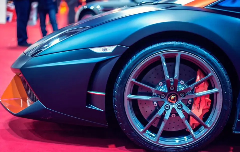 Glossy blue sports car wheel and fender after a detail