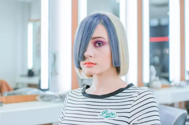 Woman with a fresh blue color in a salon chair
