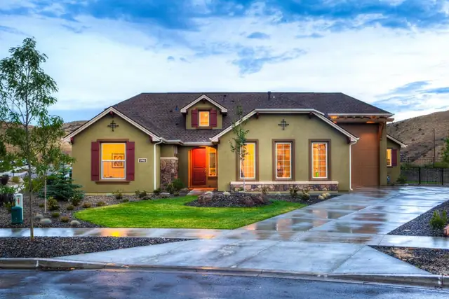 Two-story home with freshly cleaned driveway