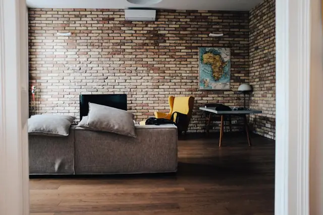 Gray sofa in a brick-walled living room