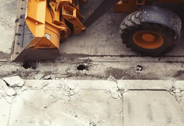 Heavy equipment breaking up an old slab