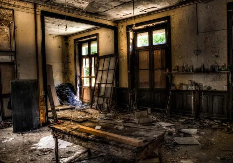 Gutted room with exposed studs and debris