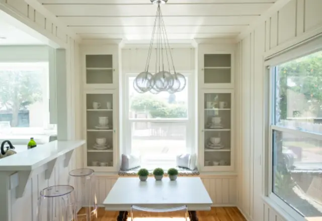 Bright finished room with white walls and dining table