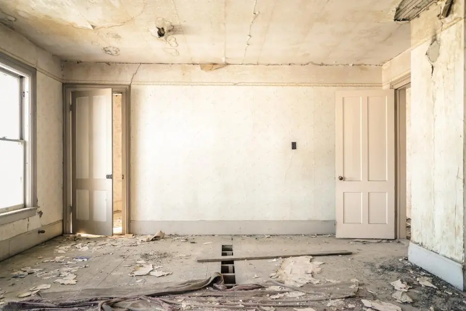 Empty room under renovation with bare walls and a window