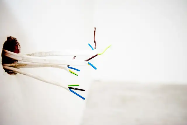 New wires coming out of a wall ready for an outlet