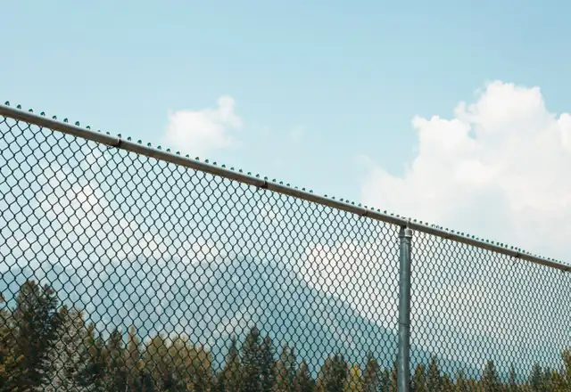Chain-link fence against a blue sky