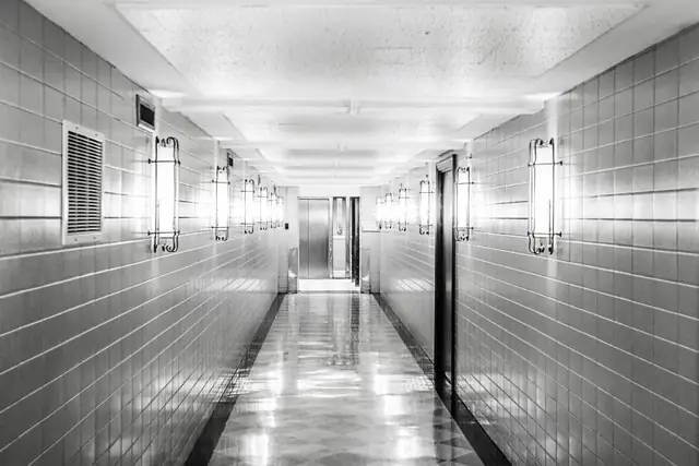 Bright hallway with glossy white tile floor