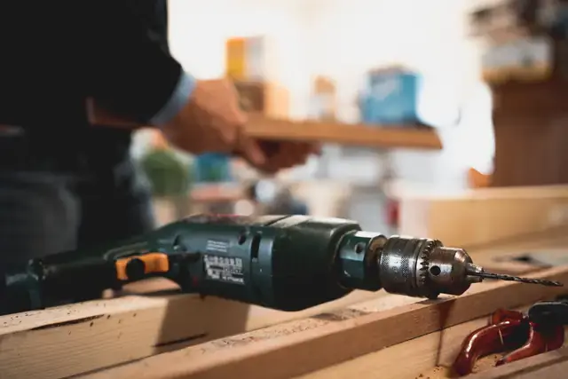 Drilling into a board on a workbench