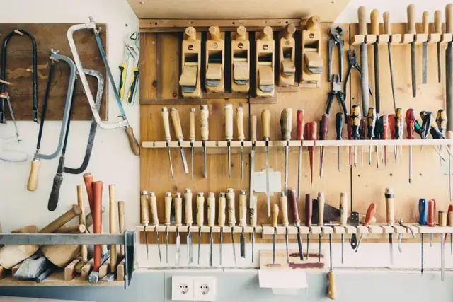 Wall of organised hand tools in a workshop