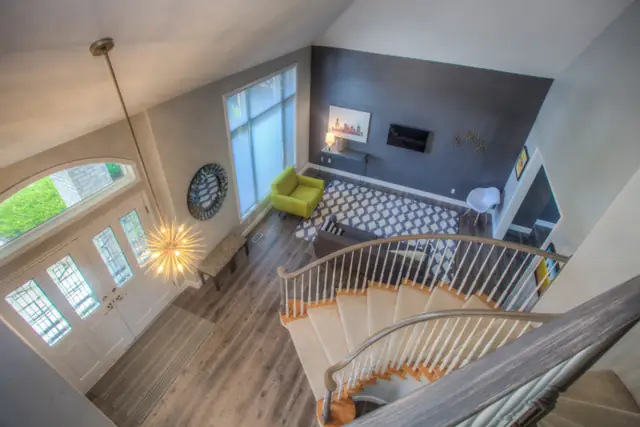Open living room with a staircase and wood floors