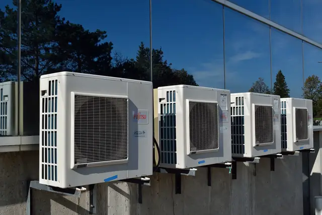 Row of ductless outdoor units on a wall
