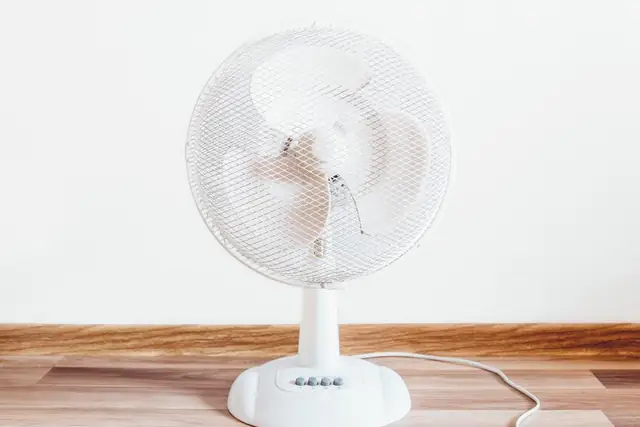 White fan on a wood floor