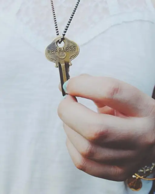 Hand holding a freshly cut house key
