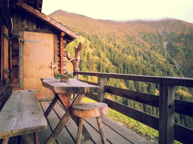 Covered wooden porch deck overlooking a valley