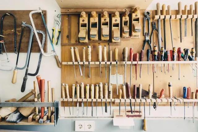 Wall of organised hand tools in a workshop