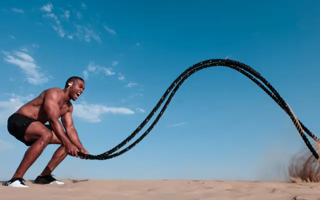 Athlete working with heavy battle ropes