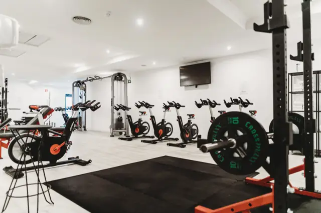 Clean gym floor with racks and bikes