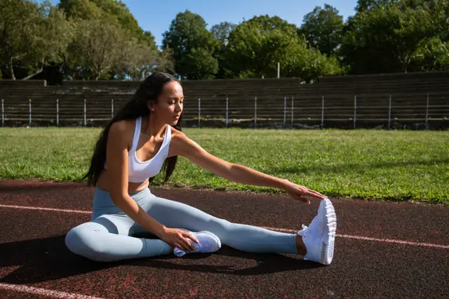 Woman stretching on a grassy field