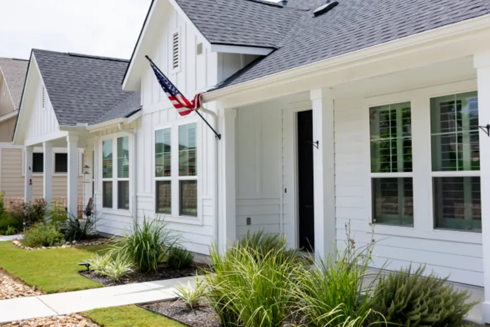 White suburban house with a green front lawn
