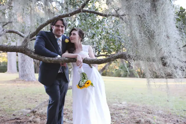 Bride and groom under a large oak tree