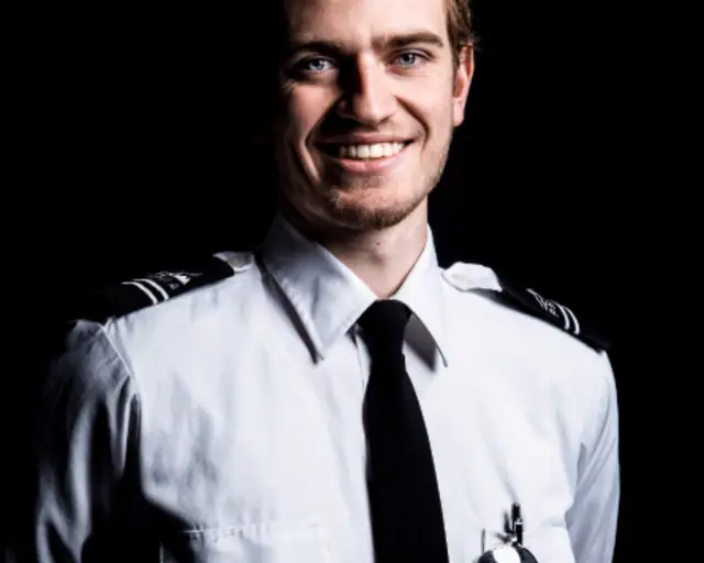 Smiling man in a uniform for a professional portrait