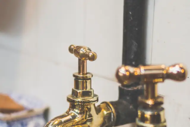 Brass taps over a bathroom sink