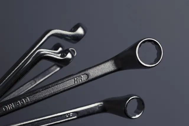 Wrenches on a dark workbench
