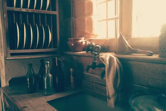 Rustic kitchen sink by a sunny window