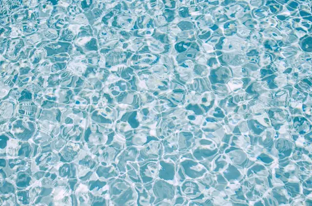 Sparkling blue pool water close up