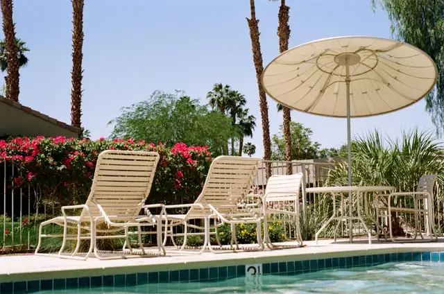 Pool deck with lounge chairs and an umbrella