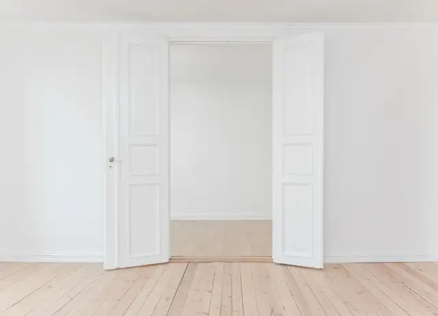 Freshly painted white room with wood floors