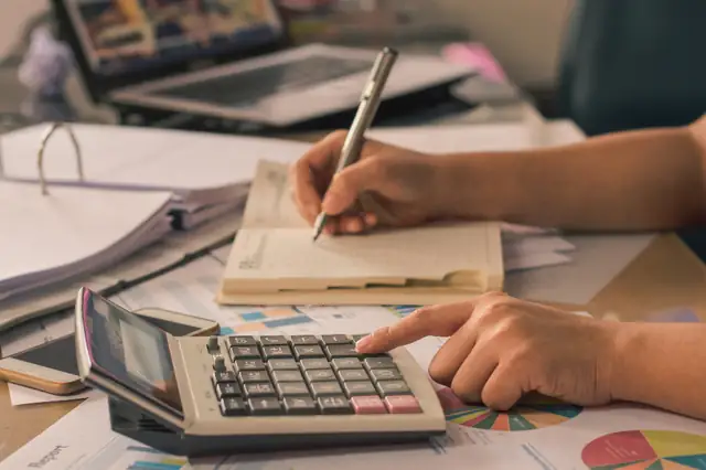 Calculator and pencil on top of homework